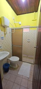 a bathroom with a shower and a toilet and a sink at Hostel Beach in Porto Seguro