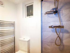a bathroom with a shower and a toilet in it at Ocean Edge in Sennen Cove +40 photos