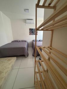 a room with two beds and a staircase in it at Casa Delta 187 in Parnaíba