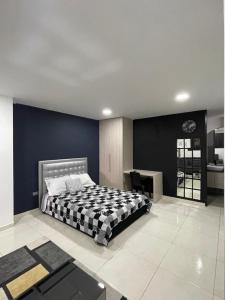 a bedroom with a bed and a blue wall at Evo Deluxe Room l Santa Rosa de Cabal in Santa Rosa de Cabal