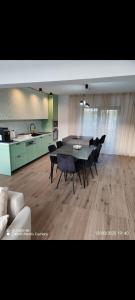 een eetkamer met een tafel en stoelen en een keuken bij Emirage Pool & Spa in Şimon