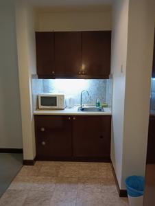 a kitchen with a sink and a microwave at Crown Suits At Times Square in Kuala Lumpur