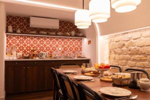 a kitchen with a wooden table with chairs around it at Joli Môme in Paris +60 photos