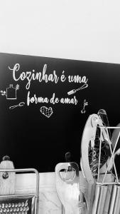 a bathroom with a sign on the wall above a sink at Apartamento com ótima localização! in Belém