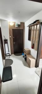 a room with a door and a table and a chair at Magic Craiova Stay in Craiova +18 photos