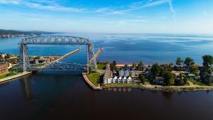 an aerial view of a bridge over a body of water at Dragestil 713 Duluth Luxury Condos by Heirloom Boutique Collection in Duluth +8 photos