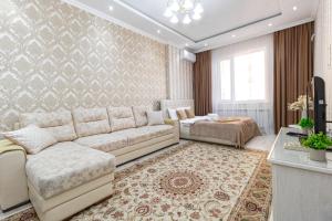TaldykolʼにあるApartments Olimp Palace2のソファとベッドのあるリビングルーム