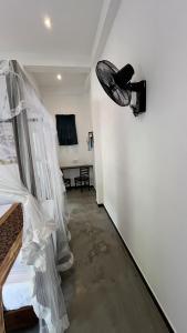 a room with a light hanging on the wall at Green Wall House in Dickwella