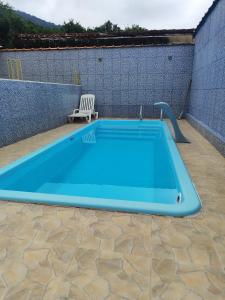 a large blue swimming pool on a patio at Casa Ubatuba Com Piscina in Ubatuba