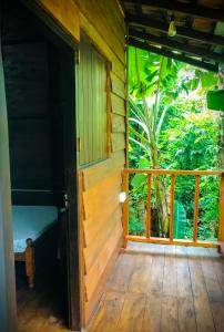 an open door to a room with a balcony at The Cinnamon Farm Wooden Cabana Unawatuna in Unawatuna