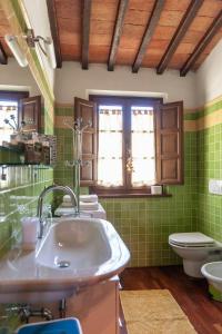 a bathroom with a sink and a toilet at Stone Villa Overlooking Panicale Vineyards in Panicale