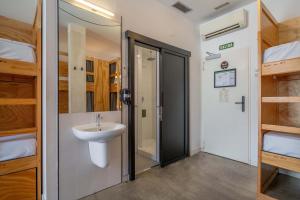 a bathroom with a sink and a walk in shower at The Hat Madrid in Madrid +41 photos