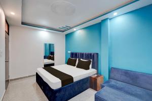 a bedroom with a bed and a couch at Hotel O Ra One Restro & Rooms in Phūlpur +21 photos
