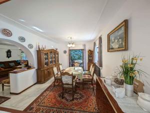 a dining room and living room with a table and chairs at Apartment Balatonszarszo - Balaton 20085 in Balatonszárszó