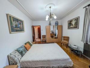 a bedroom with a bed and a couch in it at Apartment Balatonszarszo - Balaton 20085 in Balatonszárszó