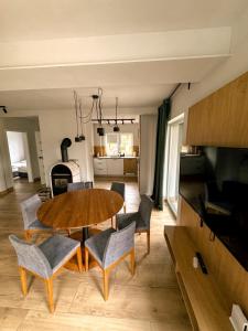 a living room with a wooden table and chairs at Apartamenty Brzozowe in Okoniny Nadjezierne