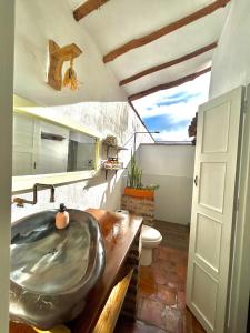 a bathroom with a sink and a toilet at Casa Castañeto Barichara in Barichara +47 photos