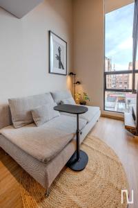 a living room with a couch and a table at NOK Luxury Studio in Chapinero in Bogotá