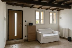 a living room with a chair and a door at Casa Boara in Ferrara