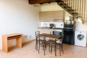 a kitchen with a table and chairs and a refrigerator at Casa Boara in Ferrara