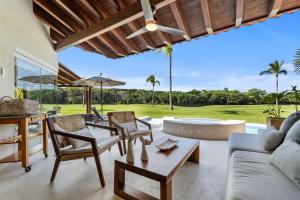 a living room with a couch and chairs and a table at Residencia Palmas en Punta Mita in Puerto Vallarta