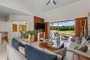 a living room with a couch and a table at Residencia Palmas en Punta Mita in Puerto Vallarta