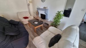 a living room with a couch and a table at Champvans centre - Appartement calme et tout confort en plein centre du village in Champvans