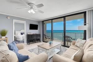 ein Wohnzimmer mit Couch und Blick aufs Meer in der Unterkunft Beachfront 2BR with Panoramic Water Views in Seagrove Beach