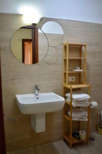 a bathroom with a sink and a mirror at Dimora normanna in Aversa +30 photos