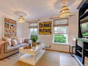 a living room with a couch and a table at 1 Bed in cotswolds 90128 in Cirencester