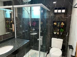 a bathroom with a shower and a toilet and a sink at Suítes Brisa do Mar, com excelente localização bem pertinho da praia de Geriba in Búzios +36 photos