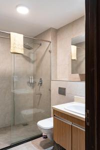 a bathroom with a shower and a toilet and a sink at Diamond Ivy Two Bedroom Apartment, Swimming pool, gym, workspace ,Wonderiss Homes Kileleshwa Living in Nairobi +45 photos