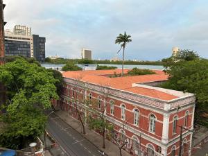 an old brick building with a palm tree on top of it at Lindo Nascer do Sol in Recife