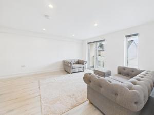 a living room with two chairs and a couch at Preston Street Apartments - by the Brighton i360 in Brighton & Hove +5 photos