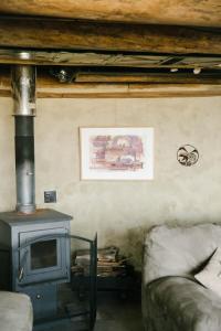 a living room with a stove and a couch at Unique and Modern Lodging with Exceptional Features in Paradise Valley, Montana in Flying Y Ranch Airport +8 photos