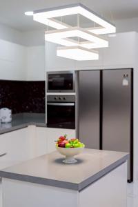 a bowl of fruit on a counter in a kitchen at Wonderland Sapphire 8 Bedroom Luxury Villa in Pattaya South +18 photos
