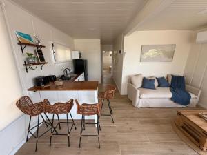 a living room with a table and chairs and a couch at LITUECHE Casa Marea in El Rosario