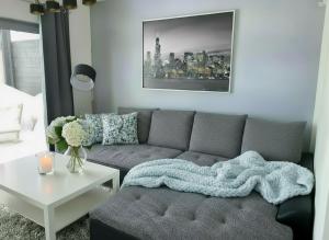a living room with a couch and a table at Casa Luisa - Trzęsacz in Trzęsacz