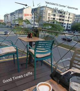 a table and chairs on a balcony with a street at INKOGNITO Centar 39 in Brčko