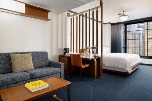 a living room with a couch and a bed at Le Meridien New York, Central Park in New York +106 photos