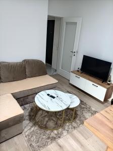 a living room with a couch and a coffee table at INKOGNITO Centar 39 in Brčko +13 photos