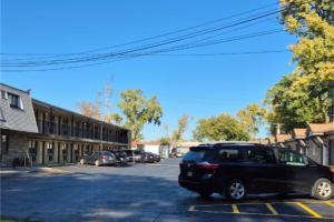 a black car parked in a parking lot at Des Plaines Motel By OYO O'Hare Airport Chicago in Des Plaines