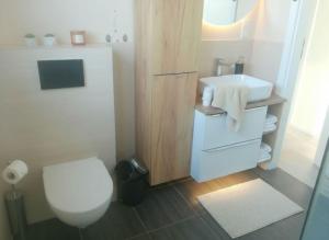 a bathroom with a white toilet and a sink at Casa Luisa - Trzęsacz in Trzęsacz +54 photos