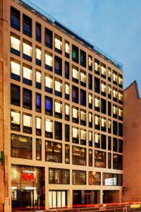 a large building with many windows on a city street at citizenM Paris Champs-Élysées in Paris
