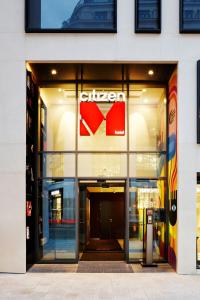 a store front with a sign on the side of a building at citizenM Paris Champs-Élysées in Paris