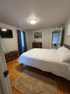 サウスベンドにある2BR Perfect Extended Stay by Notre Dame and Storesの大きな白いベッドとテレビのある寝室 +9枚の写真