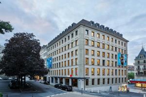 a large white building on a city street at citizenM Geneva in Geneva
