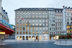 a large white building on a city street at citizenM Geneva in Geneva