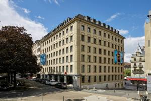 a large white building on a city street at citizenM Geneva in Geneva