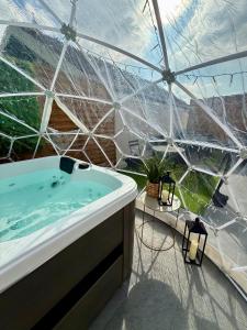a hot tub in a greenhouse with a view at Appartement jacuzzi d'exception - proche Paris in Drancy